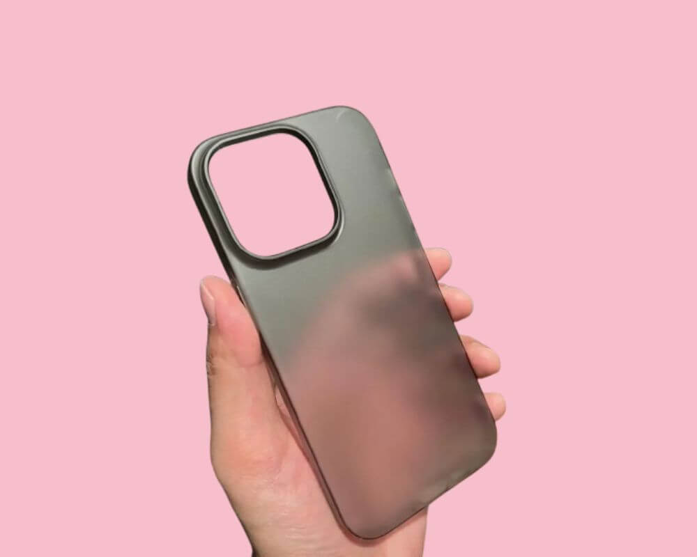 Polycarbonate hard phone case held upright in a hand, highlighting its smooth and sturdy finish